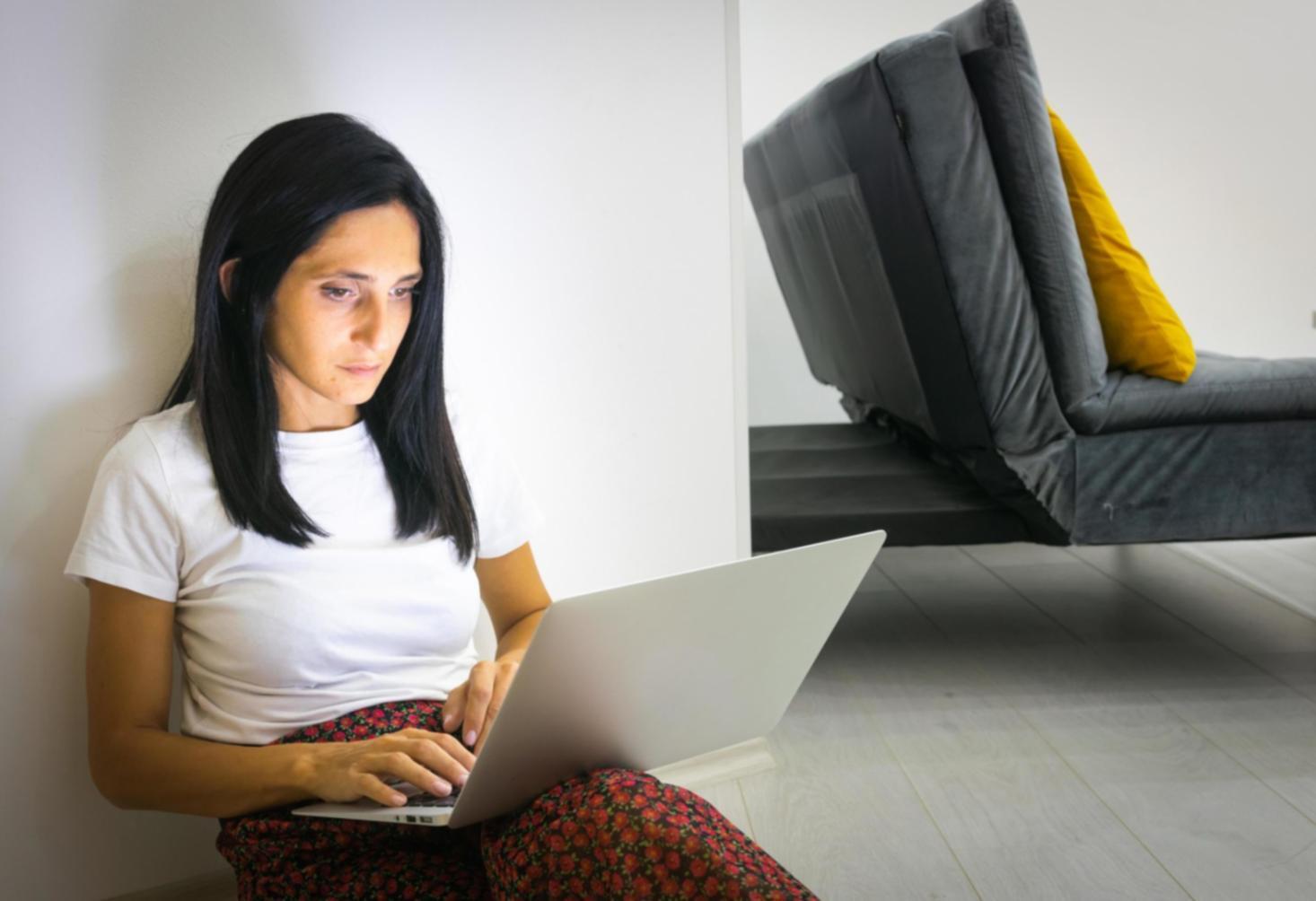 Students working through startup planning exercises with laptops and notebooks