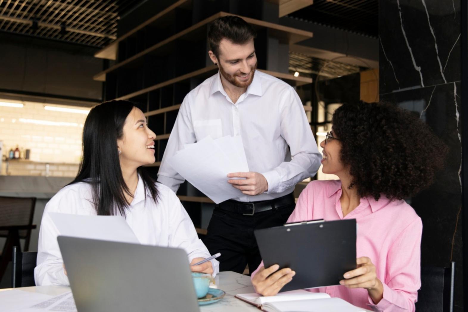 Collaborative workspace showing startup founders working together on business strategy
